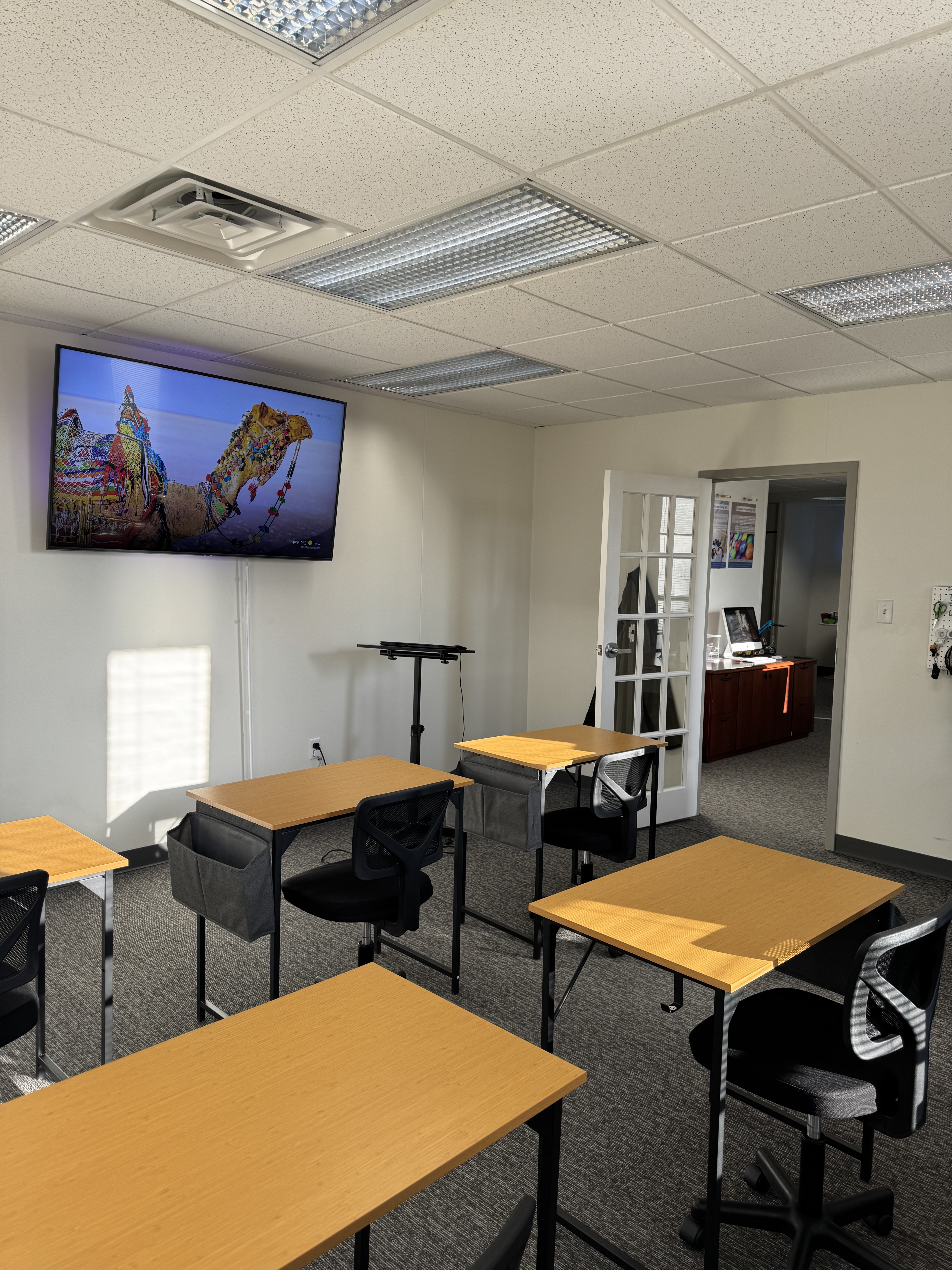 Classroom with desks and large display screen
