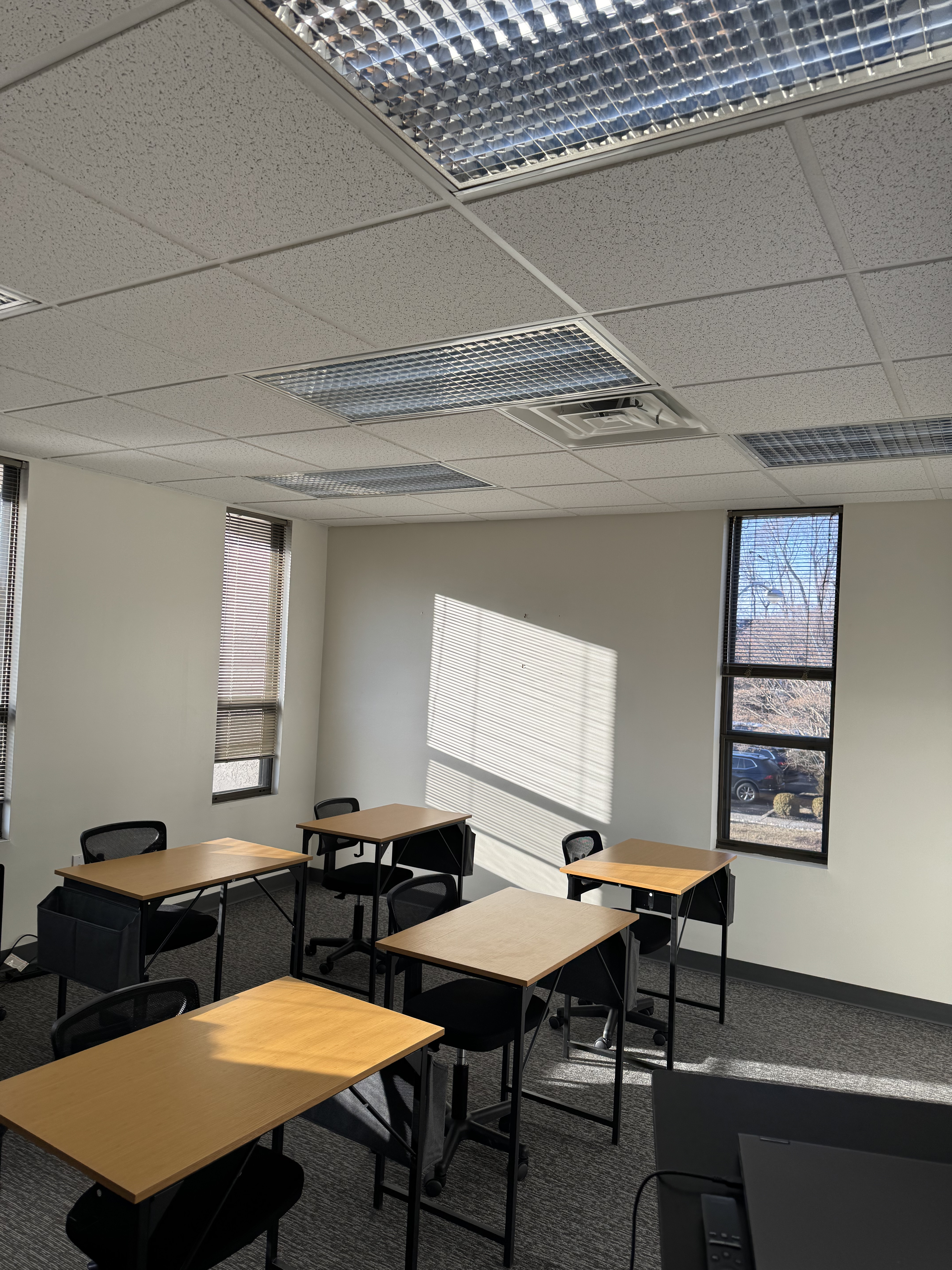 Alternative angle of classroom with desks and windows